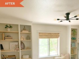 A window seat above storage drawers, with open shelves and a built-in desk alongside.