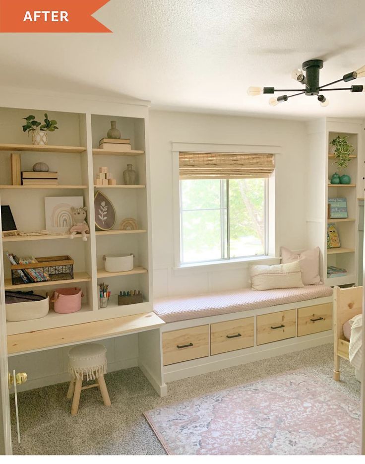 A window seat above storage drawers, with open shelves and a built-in desk alongside.